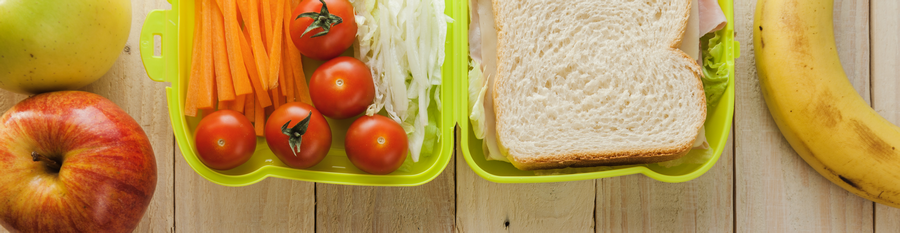 Photo of school lunch with apple, tomatoes, carrot slices, a sandwich and banana Photo of school lunch with apple, tomatoes, carrot slices, a sandwich and banana